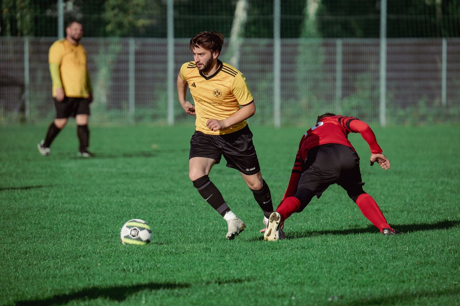 A dynamic moment captured in a soccer match with players showcasing skills on a vibrant green field.